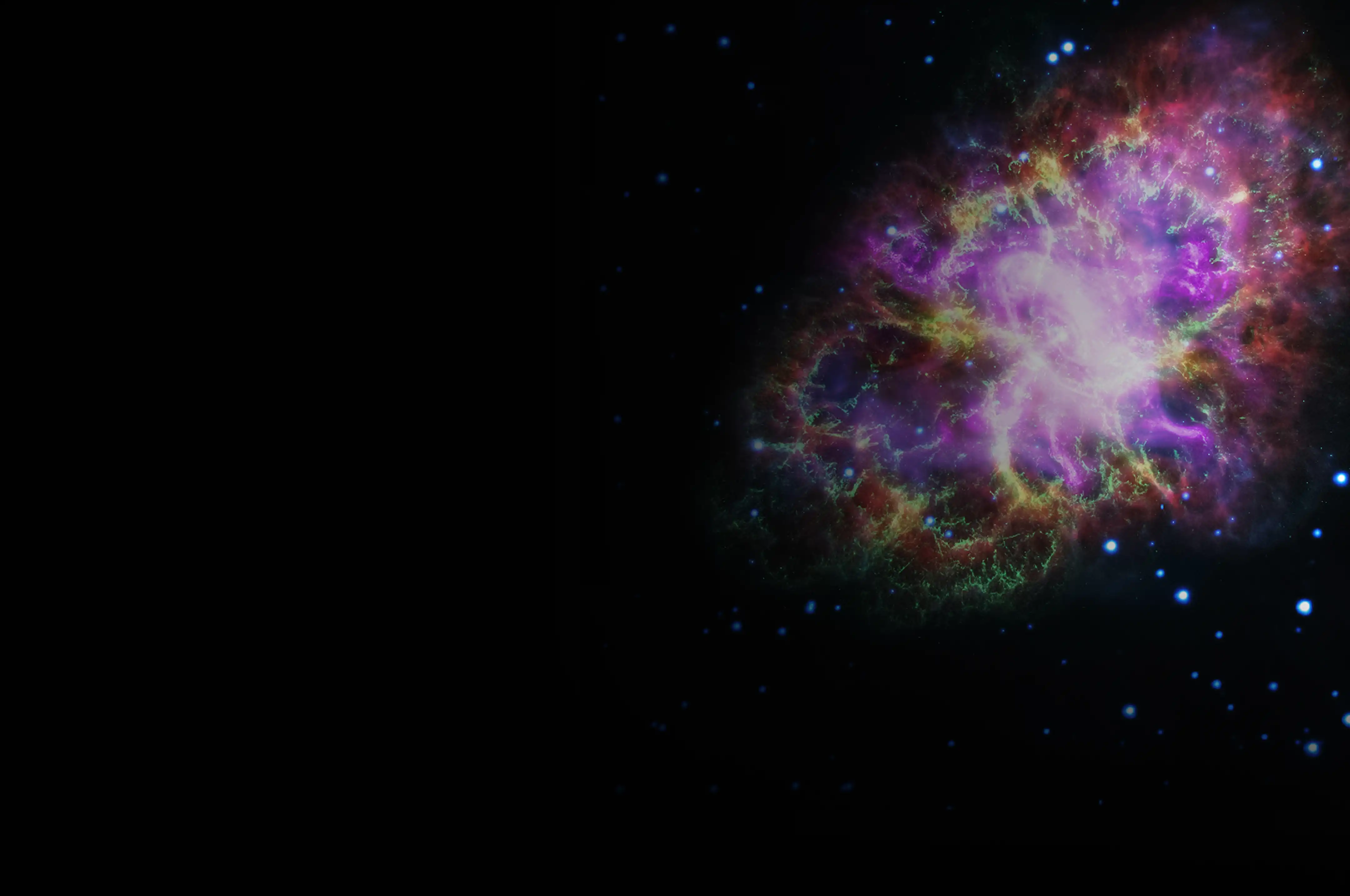 A vibrant, colorful nebula in deep space, glowing with shades of purple, pink, green, and gold against a dark star-filled background.